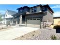 Stylish two-story home with a two-car garage and stone accents, complemented by low-maintenance landscaping at 10976 Snowdon St, Parker, CO 80134