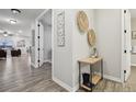 Bright hallway with a charming console table, leading to the living area and bedrooms at 2328 Saddle Back Ct, Fort Lupton, CO 80621