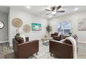 Cozy living room with stylish leather seating, a decorative rug, and ample natural light from the window at 2328 Saddle Back Ct, Fort Lupton, CO 80621