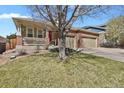 Inviting home exterior with lush lawn and a spacious three-car garage for ample parking at 2775 S Jebel Way, Aurora, CO 80013