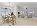 Open-concept living and dining area with abundant natural light from large windows at 2775 S Jebel Way, Aurora, CO 80013