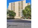 Modern apartment building features balconies, a covered entryway, and a lush tree line at 800 N Pearl St # 303, Denver, CO 80203