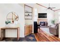 Inviting living room featuring hardwood floors, fireplace, high ceilings and a comfortable seating area at 9867 W Berry Dr, Littleton, CO 80123
