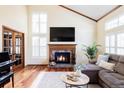 Bright living room with vaulted ceilings, fireplace, hardwood floors, and stylish decor at 9867 W Berry Dr, Littleton, CO 80123