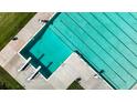 Aerial view of a pristine outdoor swimming pool with marked lanes and surrounding deck space at 9867 W Berry Dr, Littleton, CO 80123