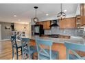 Modern kitchen featuring a granite countertop island with pendant lighting and stainless steel appliances at 12229 Circle Dr, Conifer, CO 80433