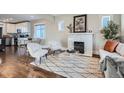 Cozy living room with a fireplace, stylish furniture, and hardwood floors at 1538 Albion St, Denver, CO 80220