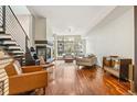 Open living space showcasing a fireplace, large windows, and hardwood flooring at 2325 Walnut St # 4, Denver, CO 80205