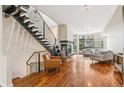 Open floor plan boasts a modern staircase, fireplace, and large windows with neighborhood views at 2325 Walnut St # 4, Denver, CO 80205