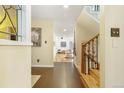 Bright foyer with tile flooring that opens to a living space and showcases a staircase with wood railing at 999 N Emerson St # 9, Denver, CO 80218