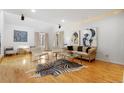 Sun-filled living room with hardwood floors, vaulted ceilings, elegant furnishings, and modern decor at 999 N Emerson St # 9, Denver, CO 80218