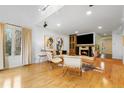 Cozy living room featuring a fireplace with a flatscreen TV, hardwood floors, and large windows for natural light at 999 N Emerson St # 9, Denver, CO 80218