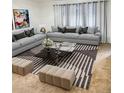 Inviting living room with comfortable sofas, patterned rug, and elegant decor for relaxation at 6495 E Happy Canyon Rd # 79, Denver, CO 80237