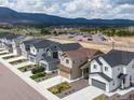 Aerial view of a neighborhood, showcasing well-maintained homes and mountain views at 16470 Mountain Flax Dr, Monument, CO 80132