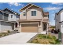 Inviting two-story home features a spacious driveway, attached garage, and manicured lawn at 16470 Mountain Flax Dr, Monument, CO 80132