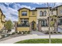 Charming, two-story home boasting a manicured lawn, stone accents, and a cozy front patio perfect for enjoying the outdoors at 15576 W Washburn Cir, Lakewood, CO 80228