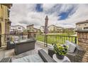 Relax on this outdoor patio with comfortable seating and a fire pit, ideal for entertaining or relaxing under the sky at 15576 W Washburn Cir, Lakewood, CO 80228