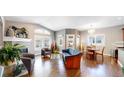 Inviting living room with fireplace, hardwood floors, and large windows for natural light at 6945 N Fargo Trl, Littleton, CO 80125