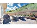Relax and unwind on this private outdoor patio with plush seating, a gas grill and hillside views at 6945 N Fargo Trl, Littleton, CO 80125