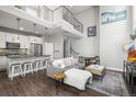 Open-concept living room and kitchen with modern furnishings, a cozy sofa, and an adjacent dining area at 1245 Utica St # 105, Denver, CO 80204