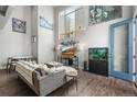 Bright living area with large windows, a comfortable sofa, entertainment center, and stylish decor at 1245 Utica St # 105, Denver, CO 80204