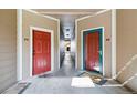 Inviting hallway with two unit entry doors and neutral color scheme at 7440 S Blackhawk St # 14-103, Englewood, CO 80112