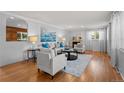 Bright living room featuring hardwood floors, a fireplace, and stylish, comfortable seating at 6243 S Elati St, Littleton, CO 80120