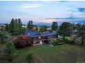 Expansive home on a sprawling lot with mature trees and lush landscaping at 8092 Ponderosa Ln, Parker, CO 80138
