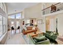 Bright living room featuring vaulted ceilings, large windows, and contemporary furnishings at 879 E 133Rd Ave, Thornton, CO 80241