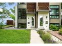 Contemporary exterior with a neatly kept lawn, walkway, and garden beds leading to the front door at 4129 Zenobia St, Denver, CO 80212
