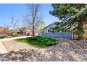 Beautiful single-story home featuring a well-maintained lawn, decorative rock landscaping, and mature trees at 860 Waite Dr, Boulder, CO 80303