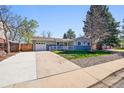 Inviting single-story home with a front porch, an attached garage, and a lush green lawn at 860 Waite Dr, Boulder, CO 80303