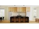 Kitchen showcasing an island with seating, modern lighting, and sleek appliances at 4303 Osceola St, Denver, CO 80212