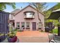 Back exterior featuring an outdoor patio area with lush greenery and a charming design at 715 Main St, Georgetown, CO 80444