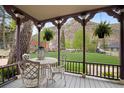Inviting porch with mountain views, wrought iron table and chairs, and hanging plants at 715 Main St, Georgetown, CO 80444