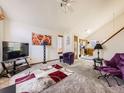 Bright living room with vaulted ceilings, contemporary decor, and an open layout to the kitchen at 11582 Depew Ct, Westminster, CO 80020