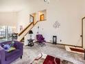 Open living space features high ceilings, carpet, and a staircase leading to the second floor at 11582 Depew Ct, Westminster, CO 80020