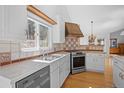 Stylish kitchen boasting stainless steel appliances, tiled backsplash, and wood floors at 28110 Meadow Dr, Evergreen, CO 80439