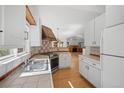 Well-equipped kitchen with stainless steel appliances, light cabinets, and breakfast bar at 28110 Meadow Dr, Evergreen, CO 80439