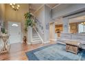 Bright and open foyer with hardwood floors, soaring ceilings, and a staircase leading to the second floor at 5934 S Yampa St, Aurora, CO 80016