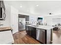 Modern kitchen featuring stainless steel appliances, an island with a sink, and lots of counter space at 2122 Opal Ave, Brighton, CO 80603
