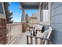 Inviting front porch with comfortable seating area perfect for relaxing and enjoying the outdoors at 1668 Rosemary Dr, Castle Rock, CO 80109