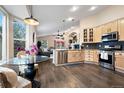 Well-lit kitchen features stainless steel appliances, light wood cabinetry, and a breakfast nook with large windows at 1668 Rosemary Dr, Castle Rock, CO 80109