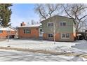 Charming two-story home with brick and siding exterior, winter landscape, and cozy curb appeal at 950 Laurel St, Broomfield, CO 80020