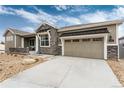 Beautiful exterior of home with a stone accents and a spacious driveway leading to the garage at 6657 S Kline Way, Littleton, CO 80127