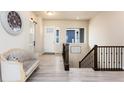 Inviting home foyer with stairs, luxury vinyl plank flooring, and modern decorations at 6657 S Kline Way, Littleton, CO 80127