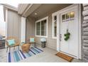 Charming front porch area with cozy seating and a welcoming atmosphere at 6657 S Kline Way, Littleton, CO 80127