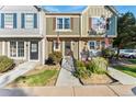 Charming townhome with colorful landscaping, a welcoming entrance, and a quaint American flag at 8140 S Fillmore Cir, Centennial, CO 80122