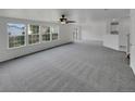 Spacious open-concept living area with ample natural light and neutral carpeting at 16453 E Phillips Dr, Englewood, CO 80112