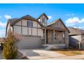 Charming two-story home boasting a stone and stucco exterior with covered porch at 1060 Marfell St, Erie, CO 80516